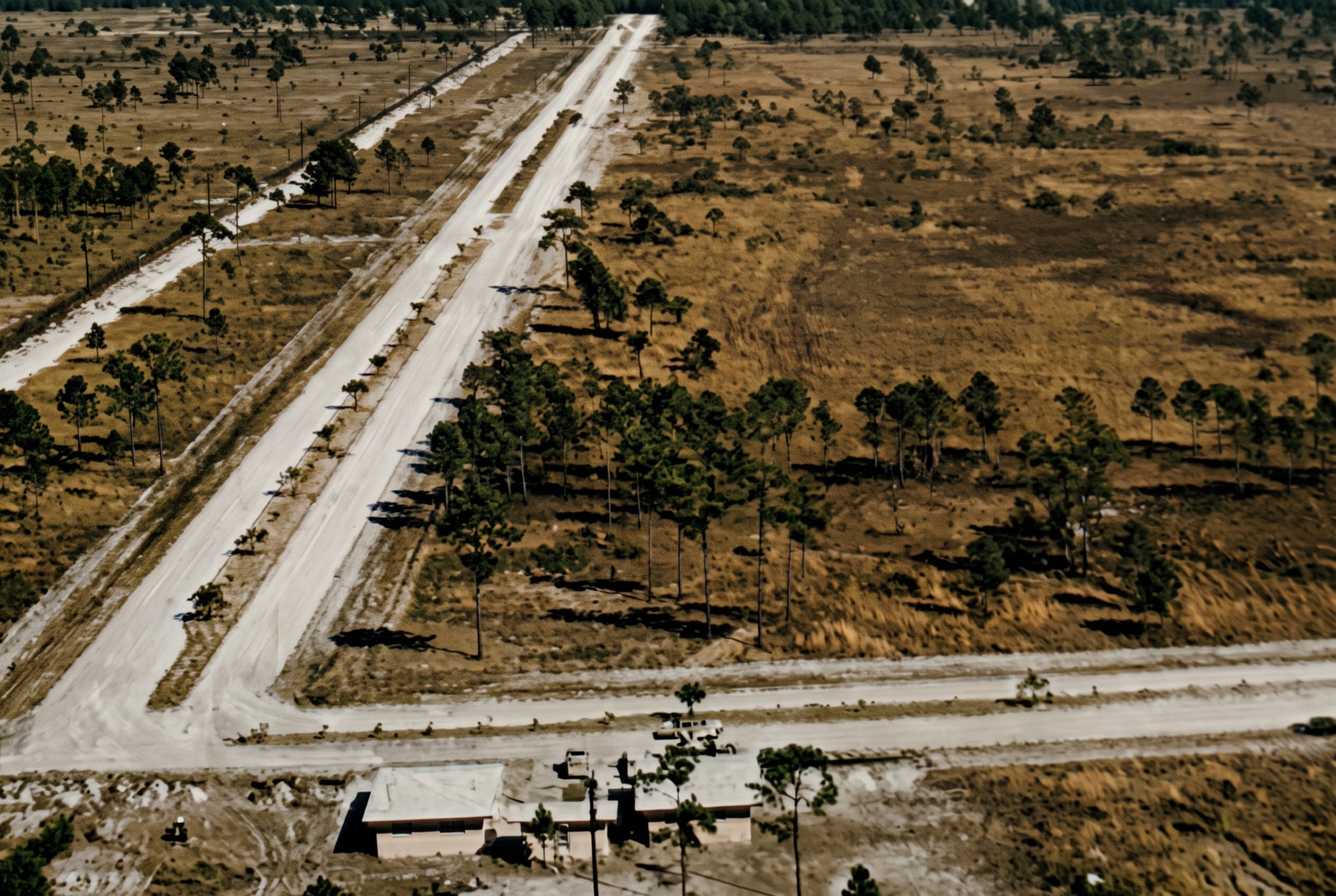 Colorized 1958 aerial of early Cape Coral roads and the first sales office