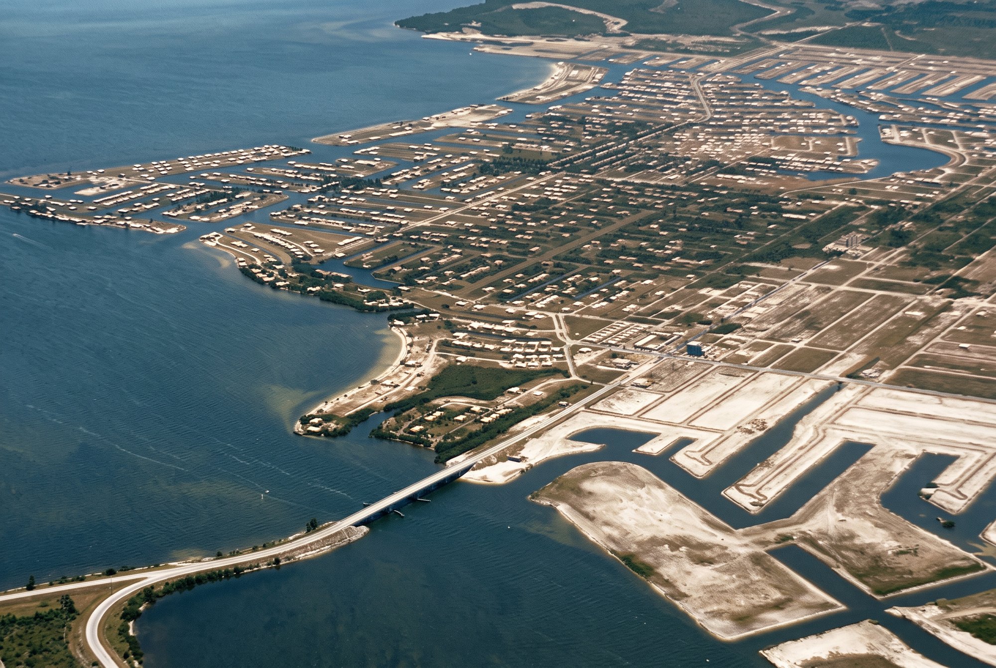 Colorized 1964 aerial of the Cape Coral Bridge over the Caloosahatchee River