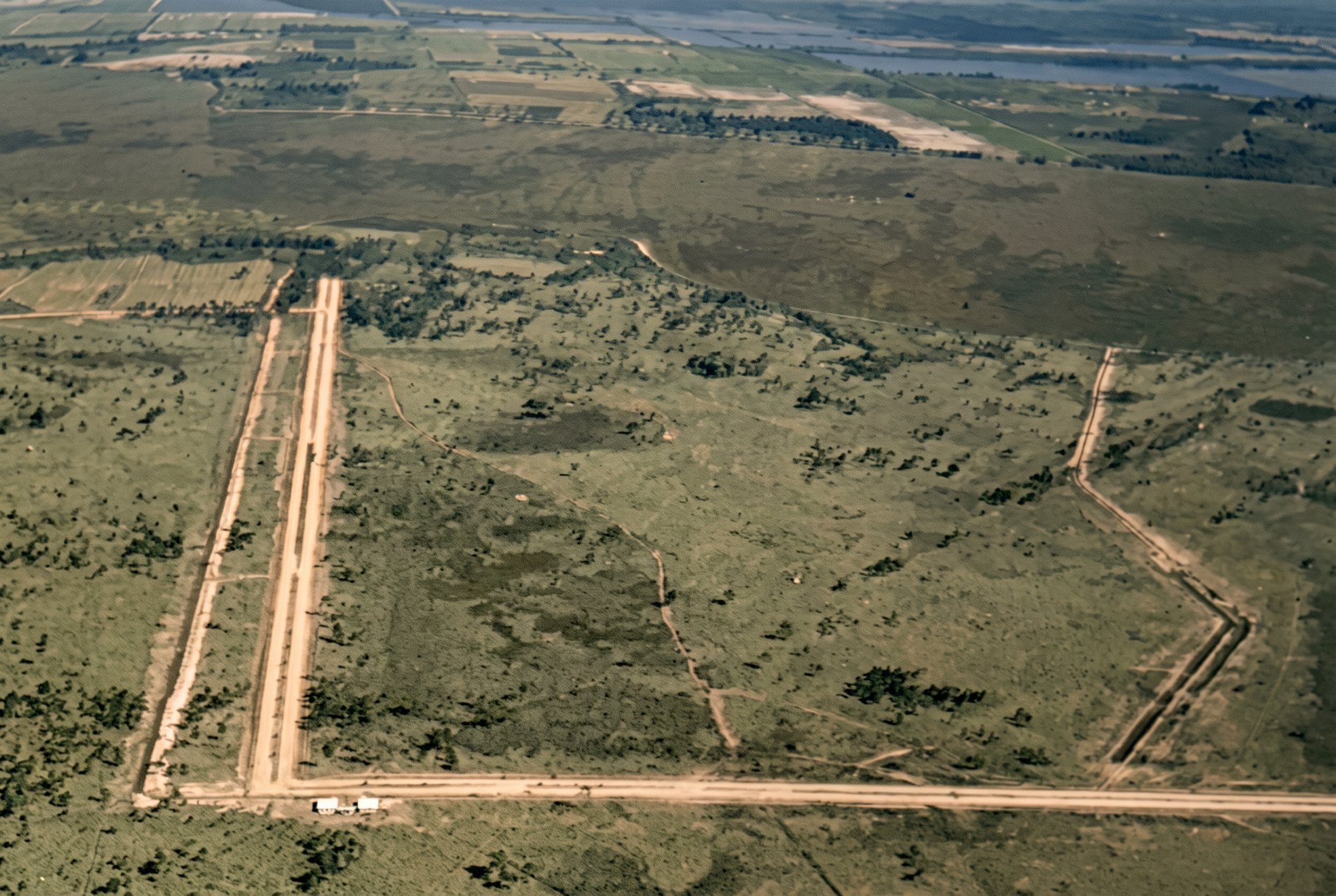 Colorized 1958 aerial of cleared Cape Coral scrubland being dug